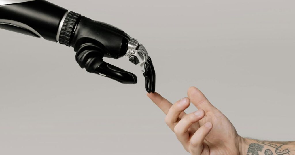 A human hand touches a robot hand